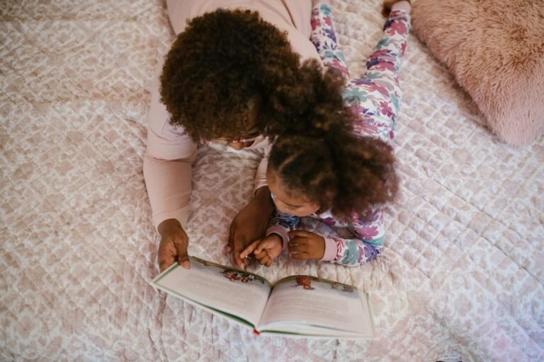 Home A mother and daughter enjoying storytime on a cozy bed, fostering bonding and togetherness.